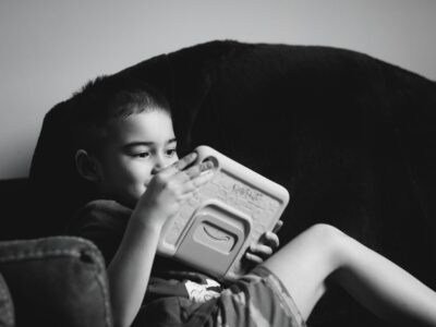 A young child engaged with a tablet device representing AI and cognitive development in children