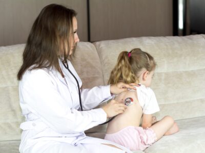 A doctor administering a vaccine to a child in a healthcare setting