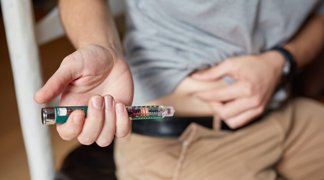 Medical injection pen representing GLP-1 weight loss drugs like semaglutide Ozempic and their expanding global health benefits