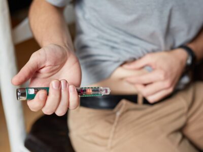 Medical injection pen representing GLP-1 weight loss drugs like semaglutide Ozempic and their expanding global health benefits