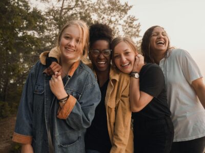A diverse group of people smiling together, representing community wellbeing and happiness