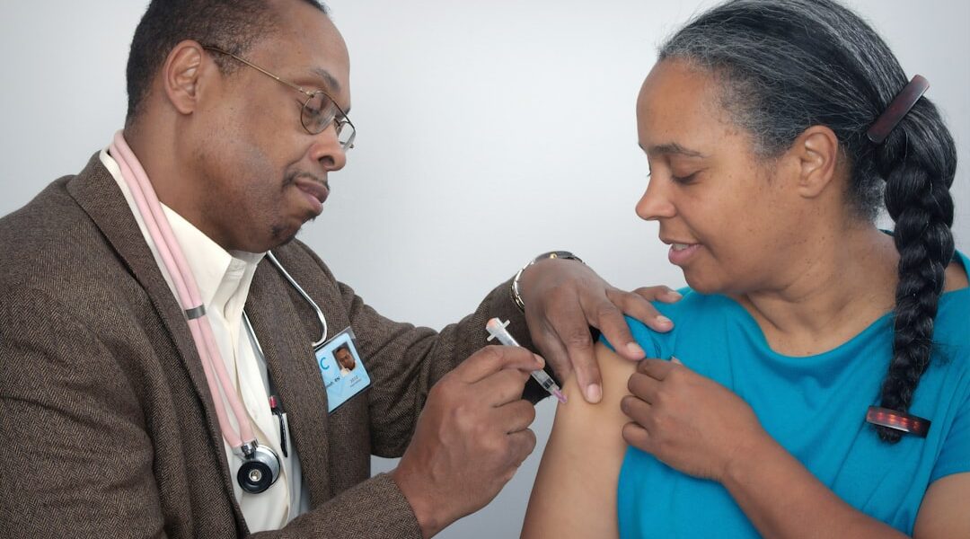 Healthcare worker administering a hepatitis vaccine injection — WHO 2026 Global Hepatitis Report highlights 1.34 million annual deaths from viral hepatitis B and C