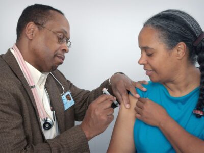 Healthcare worker administering a hepatitis vaccine injection — WHO 2026 Global Hepatitis Report highlights 1.34 million annual deaths from viral hepatitis B and C