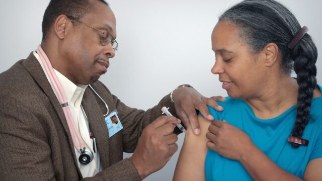 Healthcare worker administering a hepatitis vaccine injection — WHO 2026 Global Hepatitis Report highlights 1.34 million annual deaths from viral hepatitis B and C